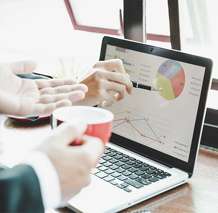 Businessman focused on laptop, analyzing data to enhance digital marketing efforts and ensure top-quality results