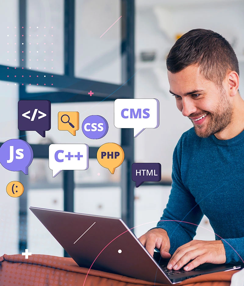 A man sitting at a laptop displaying icons, focused on impactful web development.  