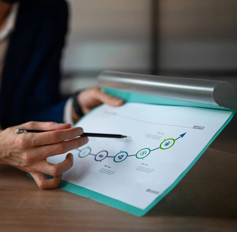Businessman holding a pen and paper displaying a graph, emphasizing the slogan 'Right Agency, Real Results.'